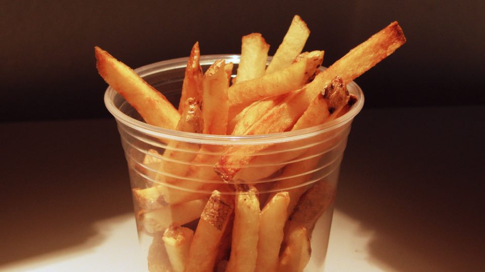 Homemade French Fries in a clear plastic cup. Number 3 most popular foods in America