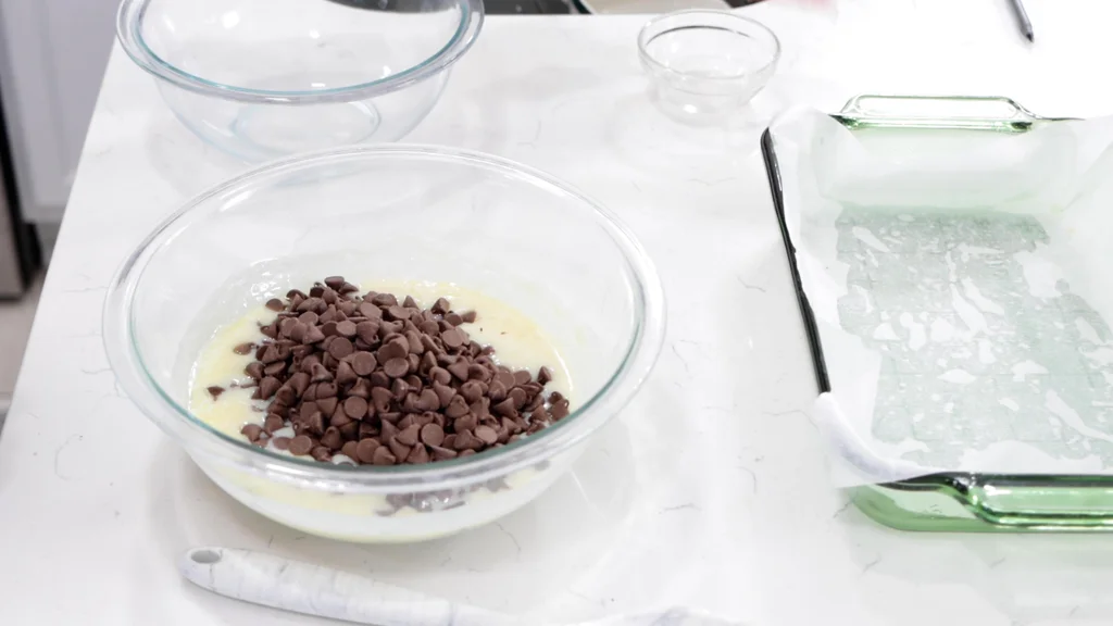 Milk chocolate chips sitting in the hot sweetened condensed milk Milk chocolate chips sitting in the hot sweetened condensed milk