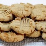 batch of peanut butter cookies sitting on wire rack