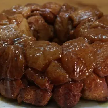 easy monkey bread nestled on a white plate on a wooden table