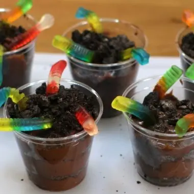 worms in dirt dessert with gummy worms coming out of oreo cookie and pudding in a cup