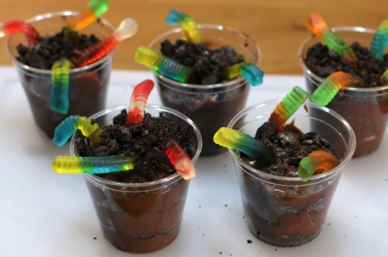 worms in dirt dessert with gummy worms coming out of oreo cookie and pudding in a cup