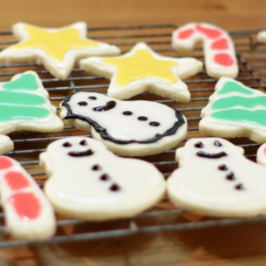 easy sugar cookies decorated and resting on a wire rack