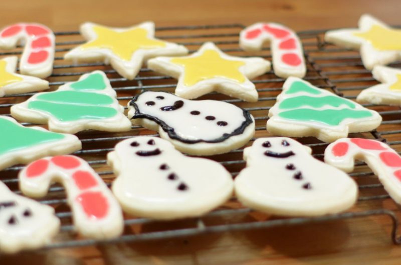 easy sugar cookies decorated and resting on a wire rack
