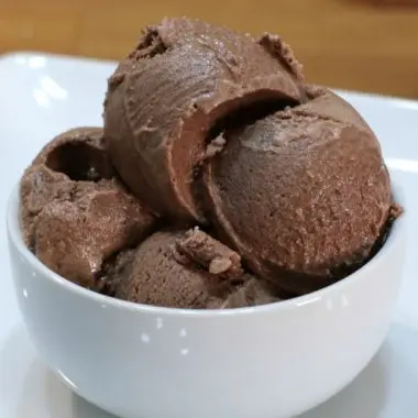 bowl of homemade chocolate ice cream sitting on a white plate