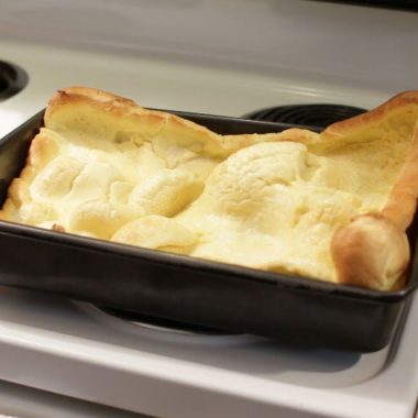 German pancakes in a 13x9 pan on a stovetop