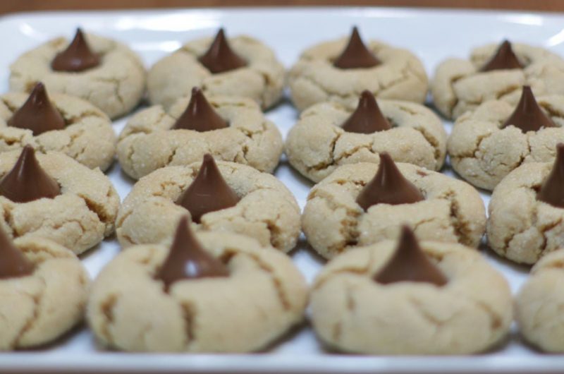 Peanut butter blossoms cookies on a white plate