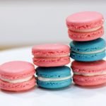 blue and pink classic French Macarons on a white cake stand