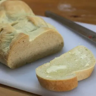 easy basic Italian bread sitting on a white cutting board next to a knife
