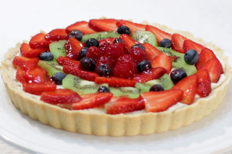 Fruit tart on a white cake pedestal