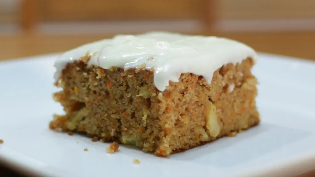Moist carrot cake on a white plate on a table