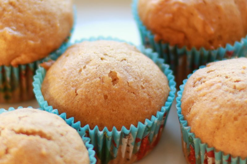 freshly baked applesauce muffins on a white plate