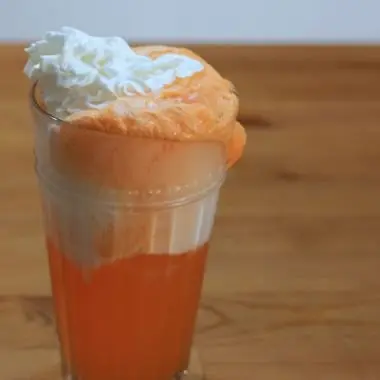 creamsicle float in a tall glass on a wooden table