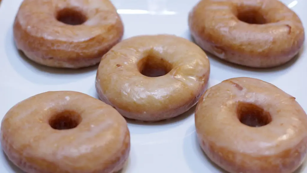 homemade glazed donuts on a white plate