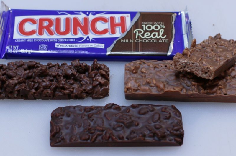 Homemade copycat Nestle crunch bars on a white cutting board.