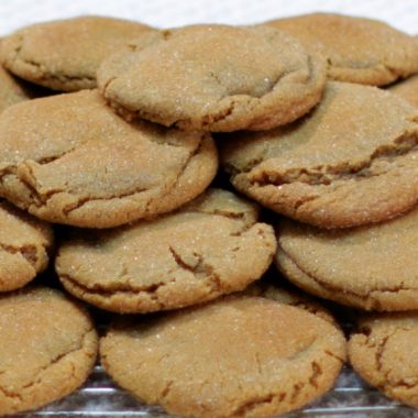 soft chewy molasses cookies piled on a wire rack