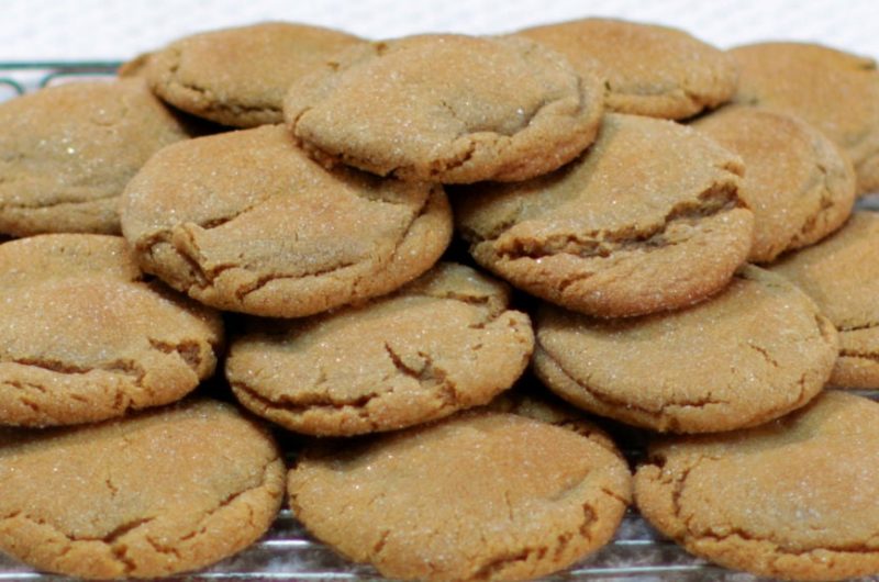 soft chewy molasses cookies piled on a wire rack