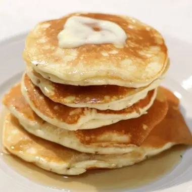 Stack of easy fluffy pancakes on a white plate