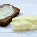Easy homemade butter on a plate with slice of banana bread
