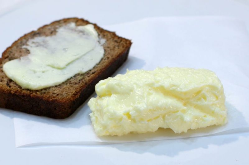 Easy homemade butter on a plate with slice of banana bread