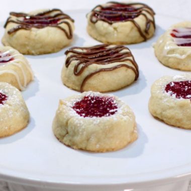 several round shortbread cookies on a white cake pedestal