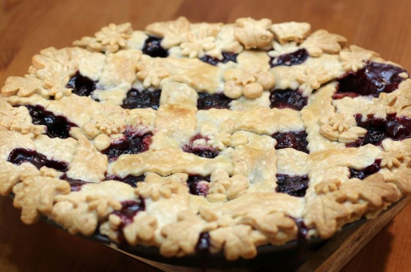 Triple berry pie on a wooden table