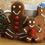 classic ginger bread men cookies standing up on a table.