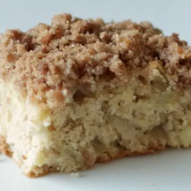 Apple streusel coffee cake on a white plate