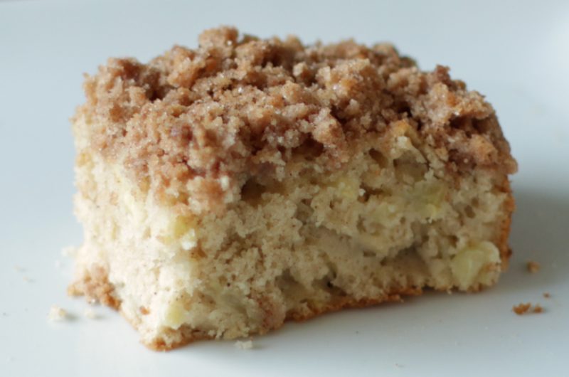 Apple streusel coffee cake on a white plate