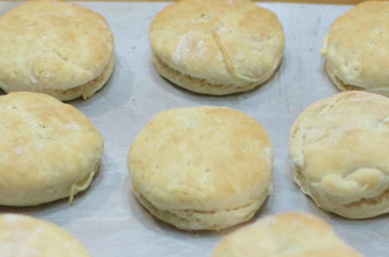 several homemade biscuits on a metal sheet pan