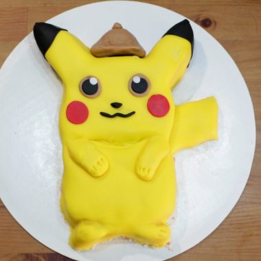 Pokemon detective pikachu cake on a white cake board