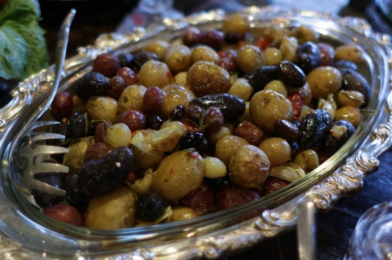 roasted baby potatoes in silver plate on table.