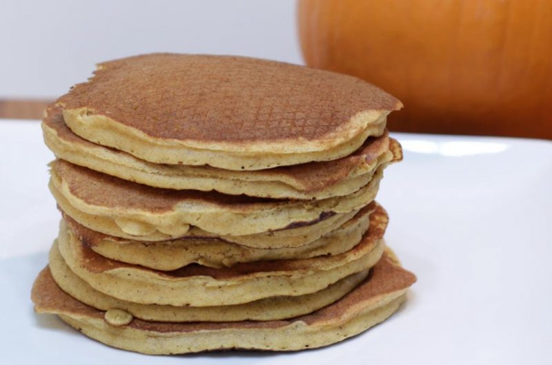 Stack of pumpkin pancakes on a white plate