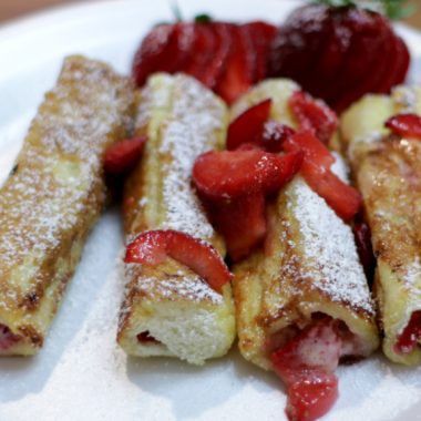 French toast roll ups on a white plate