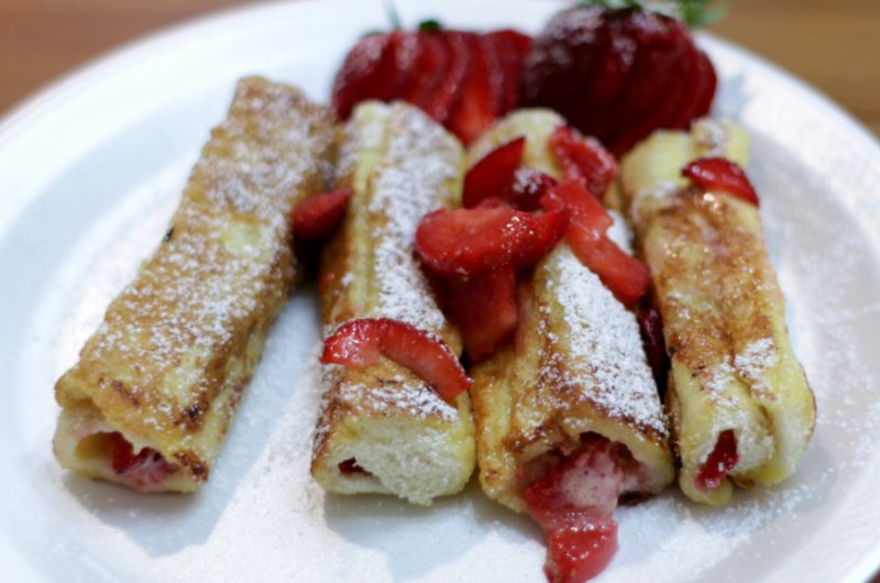 French toast roll ups on a white plate