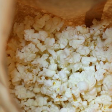 homemade microwave popcorn in a brown paper bag.