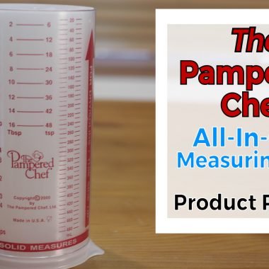 Pampered chef measure all measuring cup on top of a wooden table.