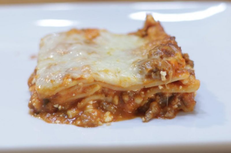 Easy homemade lasagna on a white plate.