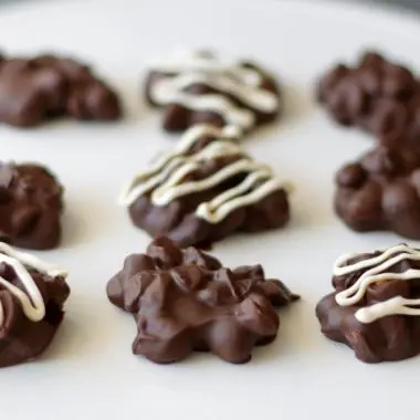 chocolate peanut clusters on a white plate
