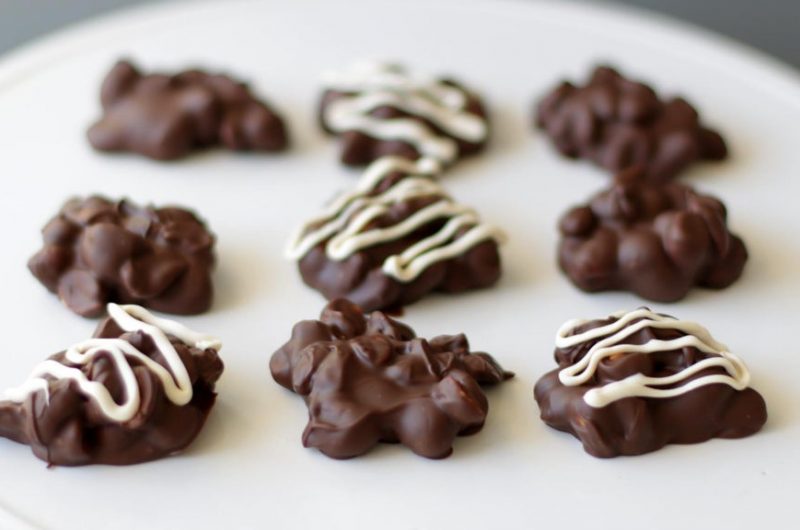 chocolate peanut clusters on a white plate