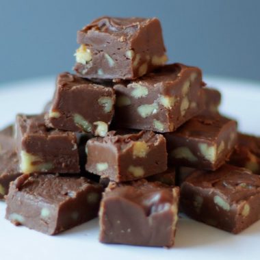 stack of creamy old fashioned fudge on a white plate.