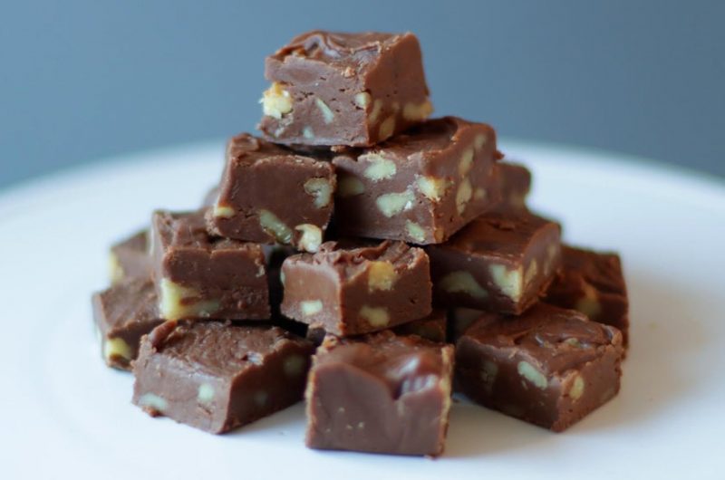 stack of creamy old fashioned fudge on a white plate.