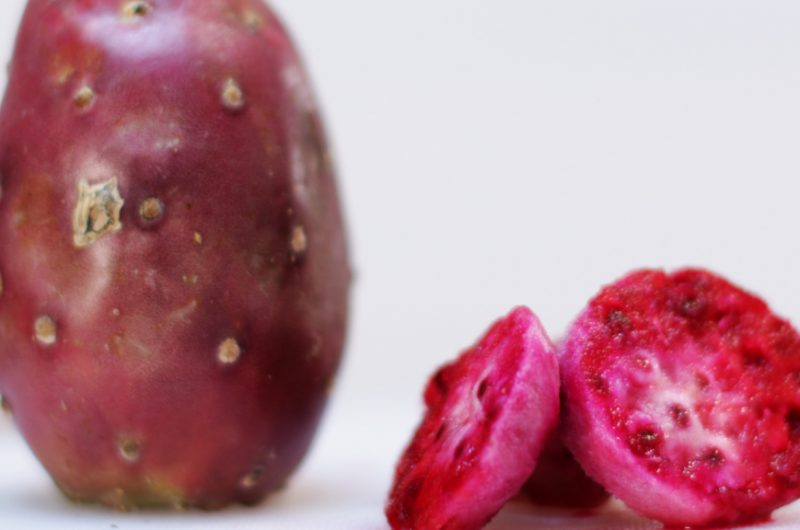 prickly pear on a white cutting board on a table.