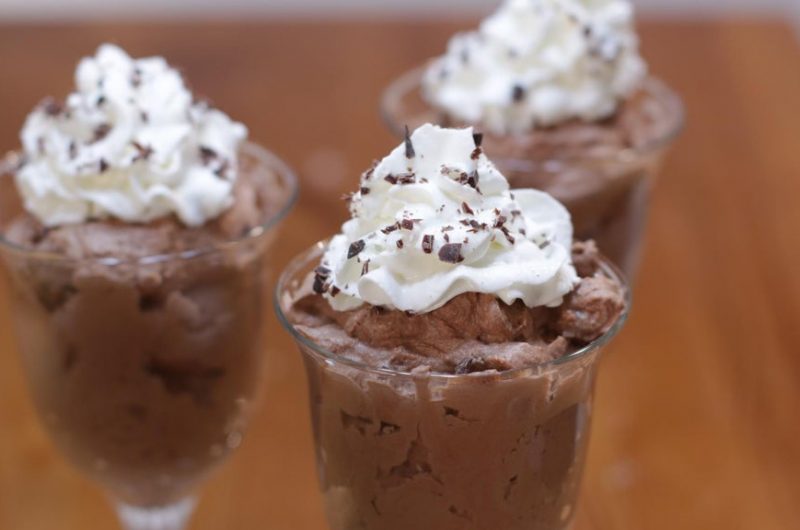 Chocolate mousse in glasses topped with whipped cream