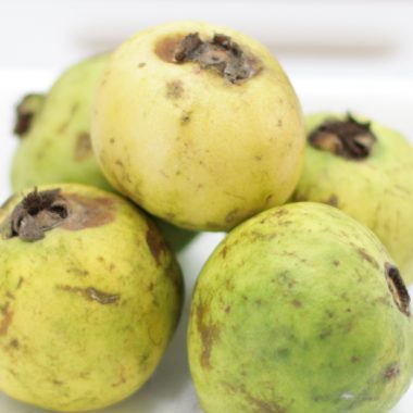 Pile of Mexican Guavas on a white plate.