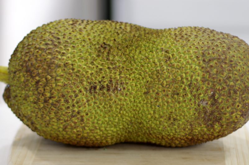 Large jackfruit on a countertop.