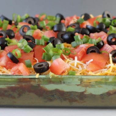 glass dish filled with 7 layer bean dip