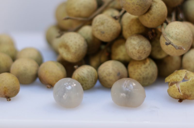 Longan fruit on a white cutting board
