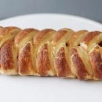 Braided strawberry puff pastry on a white plate