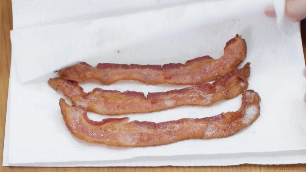 Air fryer bacon on a white paper towel